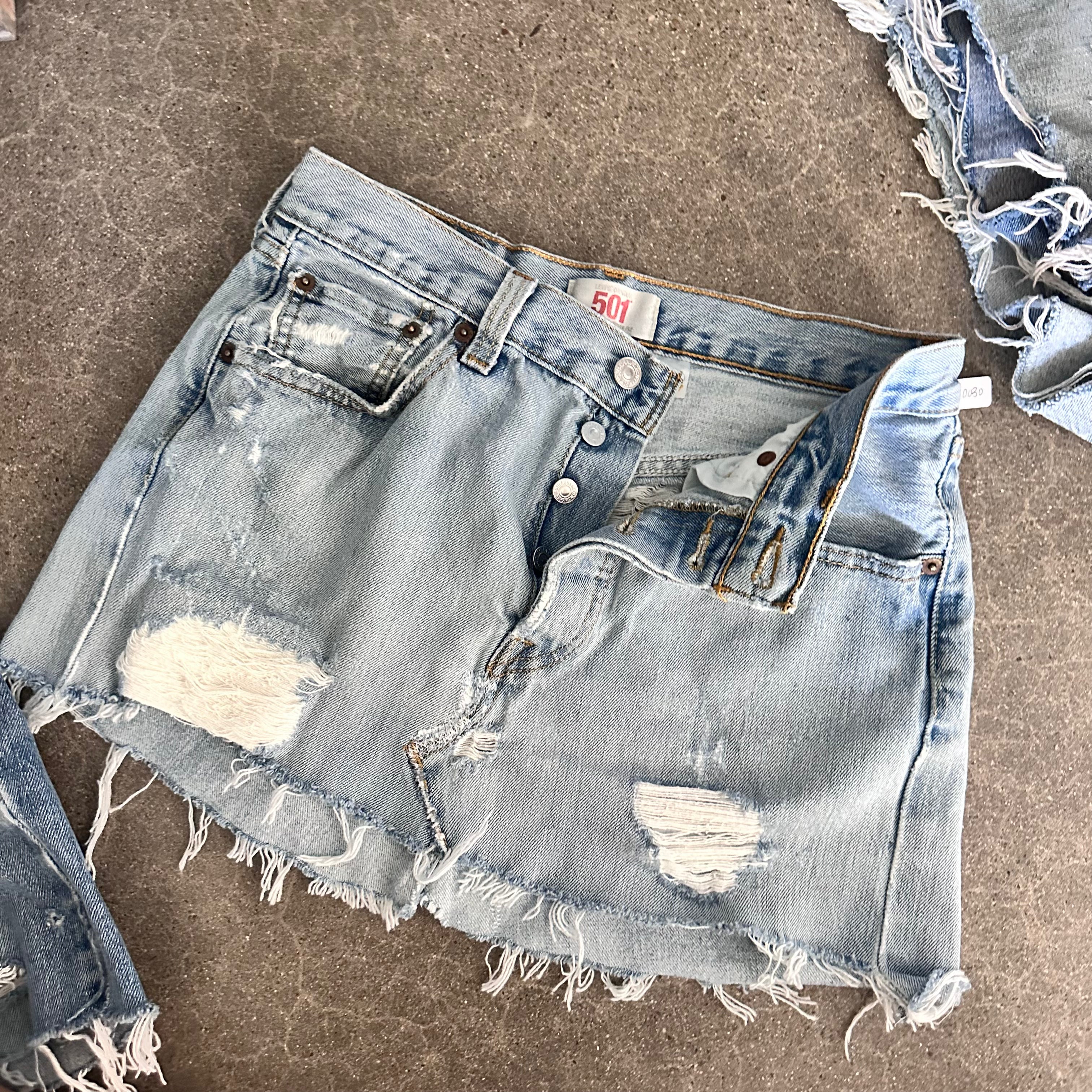 Destroyed Levi’s reworked mini skirt 14” flat lay