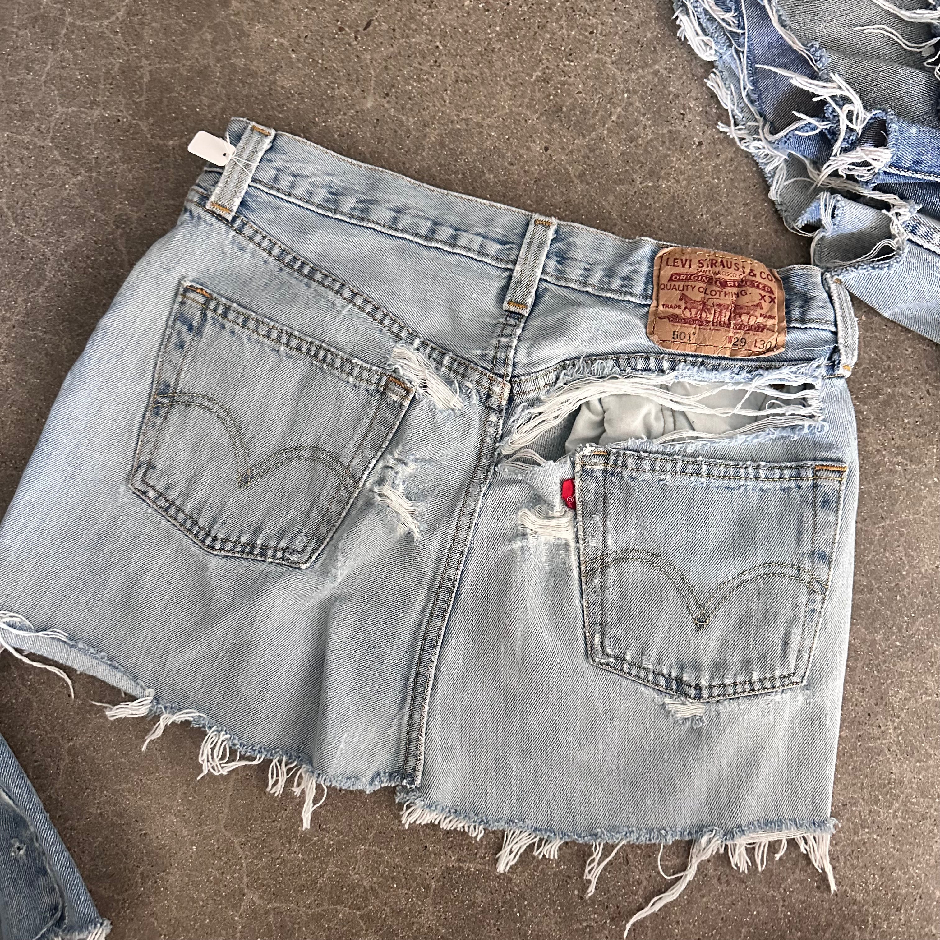 Destroyed Levi’s reworked mini skirt 14” flat lay